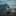 Teenager sitting on a dock by herself looking at the calm water