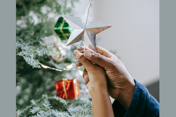 Child holding a Christmas star to put on tree